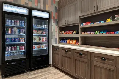 a kitchen with two refrigerators with food and drinks at Homewood Suites By Hilton Santa Clarita/Valencia, Ca in Santa Clarita