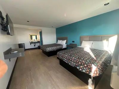 a hotel room with two beds and a television at Arlo Motel near LAX, SoFi Stadium in Inglewood