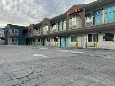 an empty parking lot in front of a hotel at Arlo Motel near LAX, SoFi Stadium in Inglewood