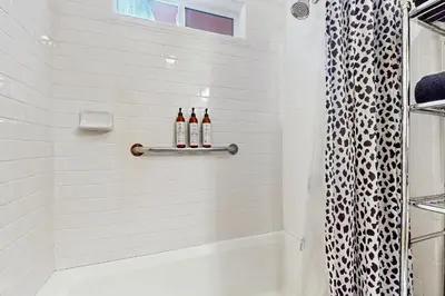 two bottles of wine sitting on a shelf in a bathroom at Babbling Brook in Lake Arrowhead