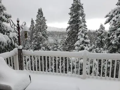 a white fence covered in snow with trees at Kid's Paradise! Ball Pit 2 Lofts Lakeview 5 bd, 3ba in Lake Arrowhead