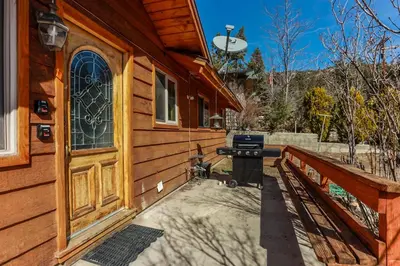 a barbecue grill on the side of a house at Shasta Mountain Cabin - 1916 by Big Bear Vacations in Big Bear City