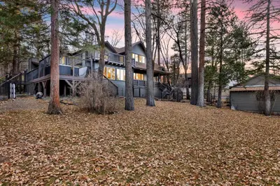a large house with trees in front of it at Splash Mountain - 1904 by Big Bear Vacations in Big Bear Lake