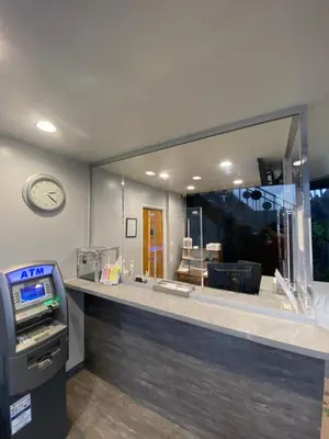 a counter with a cash register and a large mirror at Sandman Motel in Los Angeles
