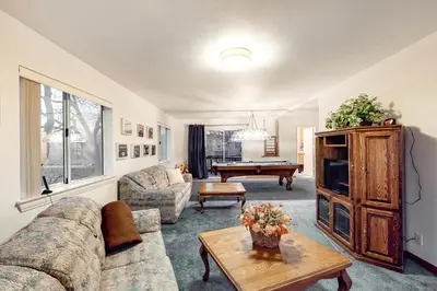 a living room with a couch and a pool table at The House Of Light and Sky in Lake Arrowhead