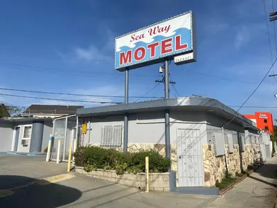 a sign for a motel on top of a building at Seaway Motel in Los Angeles