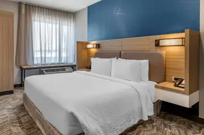 a large white bed in a hotel room at SpringHill Suites by Marriott Anaheim Placentia Fullerton in Placentia