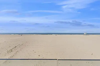 a beach with footprints in the sand and the ocean at Savor the View in Oxnard