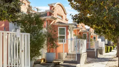 a row of houses with a white fence at Art Deco by AvantStay in Los Angeles