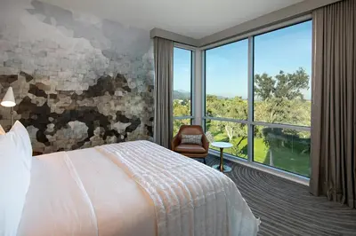 a hotel room with a bed and a large window at Le Meridien Pasadena Arcadia in Arcadia