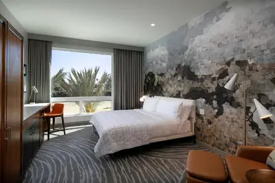a bedroom with a bed and a brick wall at Le Meridien Pasadena Arcadia in Arcadia