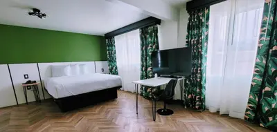 a bedroom with a bed and a green wall at The Bell Vista in Burbank
