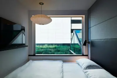 a bedroom with a bed and a large window at citizenM Los Angeles Downtown in Los Angeles