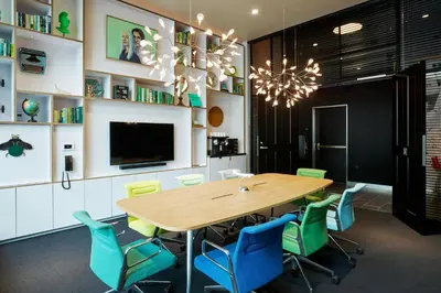a dining room with a wooden table and blue chairs at citizenM Los Angeles Downtown in Los Angeles