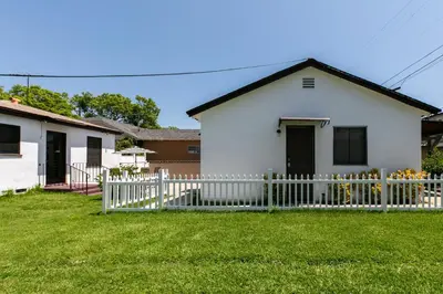 a white house with a white picket fence at Heartwell Park Beauty Long Beach in Long Beach