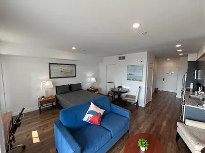 a living room with a blue couch and a bed at Modern Luxury Apartments in the Heart of Los Angeles in Los Angeles