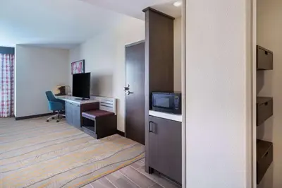 an empty hotel room with a desk and a computer at Hilton Garden Inn Chino Hills Pomona CA in Pomona