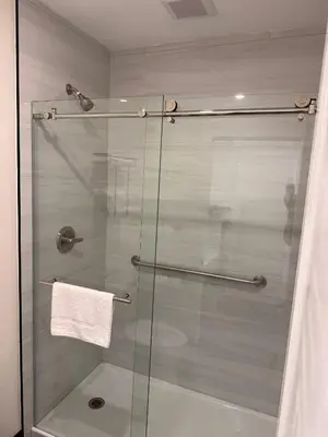 a shower stall with a glass door in a bathroom at SOFI MOTEL in Los Angeles