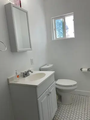 a bathroom with a sink and a toilet and a mirror at The California - Hollywood in Los Angeles