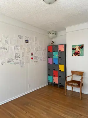a room with a wall covered in drawings and papers at The California - Hollywood in Los Angeles