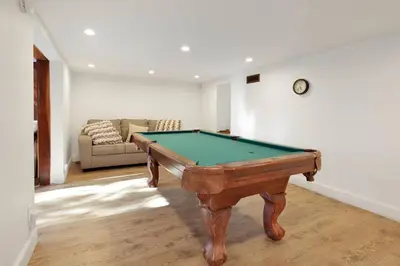 a pool table in a living room with a couch at Conklin Paradise #1993 by Big Bear Vacations in Big Bear Lake