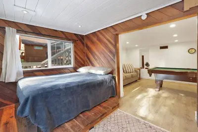 a bedroom with a bed and a pool table at Conklin Paradise #1993 by Big Bear Vacations in Big Bear Lake
