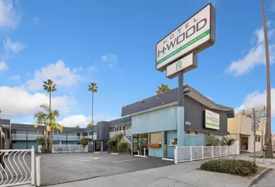 a sign in a parking lot in front of a hotel at Hotel H-Wood in Los Angeles
