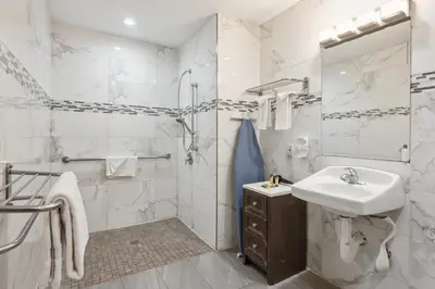 a white bathroom with a sink and a shower at Hotel H-Wood in Los Angeles