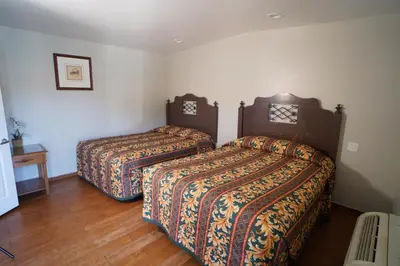 two beds in a hotel room with two beds at The Fly Inn Motel in Lynwood