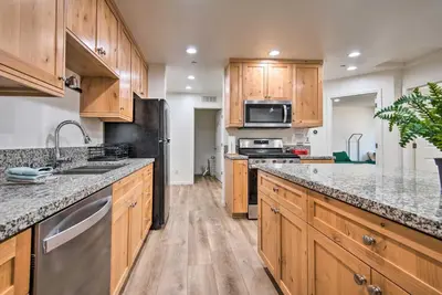 a kitchen with wooden cabinets and stainless steel appliances at Pine Mountain Club Villa with Sauna, Deck and Views! in Pine Mountain Club