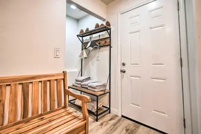 a walk in closet with a wooden bench and a door at Pine Mountain Club Villa with Sauna, Deck and Views! in Pine Mountain Club