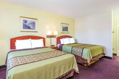 a hotel room with two beds in a room at Super 8 by Wyndham Bakersfield/Central in Bakersfield