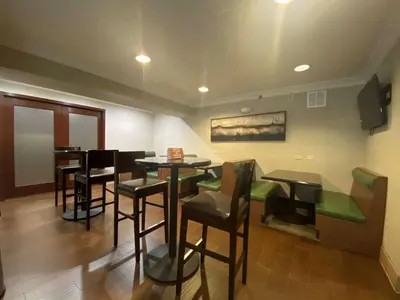 a restaurant with tables and chairs in a room at SureStay Hotel by Best Western Ontario Airport in Ontario