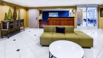 a living room with a couch and a table at SureStay Hotel by Best Western Ontario Airport in Ontario