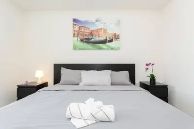 a bedroom with a bed with two towels on it at Luxury Highrise Living Downtown LA in Los Angeles