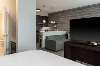a living room with a couch and a flat screen tv at Residence Inn by Marriott Lancaster Palmdale in Lancaster