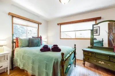 a bedroom with a bed with a mirror and a dresser at Alpine Dream in Crestline