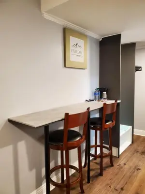 a kitchen with a table and two bar stools at Hotel Europa in Smeltzer