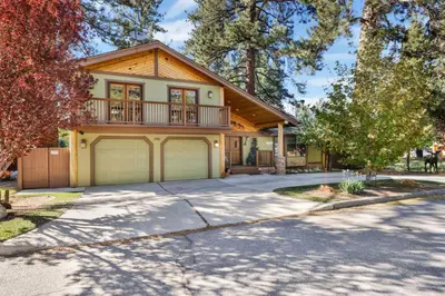 a house with a balcony and a garage at Moose Manor #2012 by Big Bear Vacations in Big Bear Lake