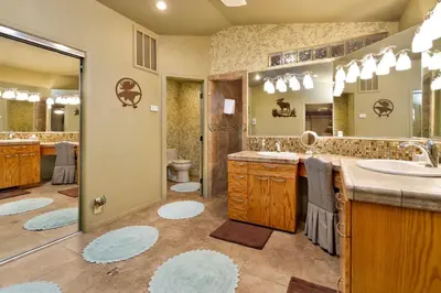 a bathroom with a sink and a toilet and a mirror at Moose Manor #2012 by Big Bear Vacations in Big Bear Lake