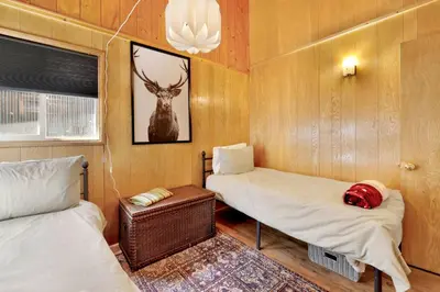 a room with two beds and a deer picture on the wall at Marin Getaway #2013 by Big Bear Vacations in Big Bear Lake