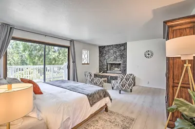 a bedroom with a bed and a fireplace at Boho-Chic Home with Game Room Near Lake Gregory! in Crestline