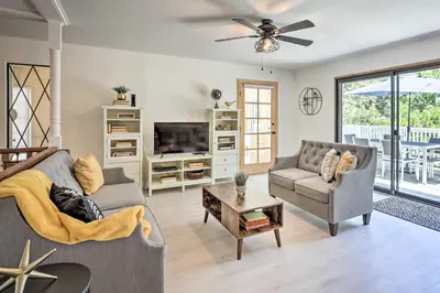 a living room with a couch and a tv at Boho-Chic Home with Game Room Near Lake Gregory! in Crestline