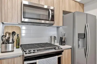 a kitchen with a stainless steel stove and a microwave at 4 SantaMonica De Lux in Los Angeles