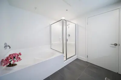 a white bathroom with a shower and a sink at 4 SantaMonica De Lux in Los Angeles