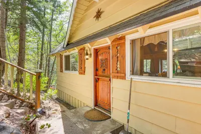 a house with a wooden door and a window at Game Room and 2 Decks Walkable Lake Arrowhead Cabin in Lake Arrowhead