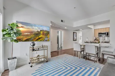 a living room with a table and a kitchen at 7 Large Down Town Santa Monica Apartment in Los Angeles