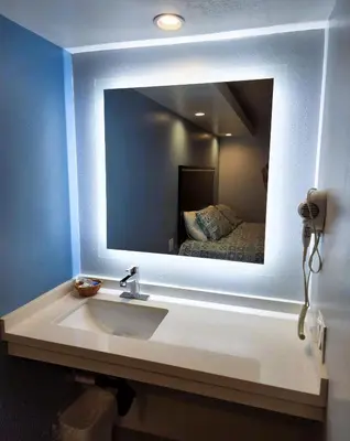 a bathroom with a sink in front of a mirror at DAY N NIGHT INN - Near Universal Studios Hollywood in Los Angeles