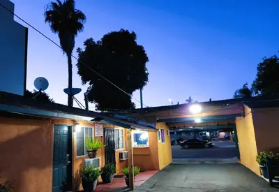 a car is driving through a garage at night at DAY N NIGHT INN - Near Universal Studios Hollywood in Los Angeles