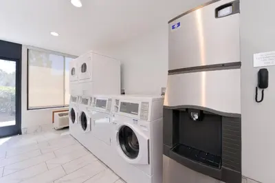 a white laundry room with a washer and dryer at Fairfield Inn and Suites by Marriott Bakersfield Central in Bakersfield